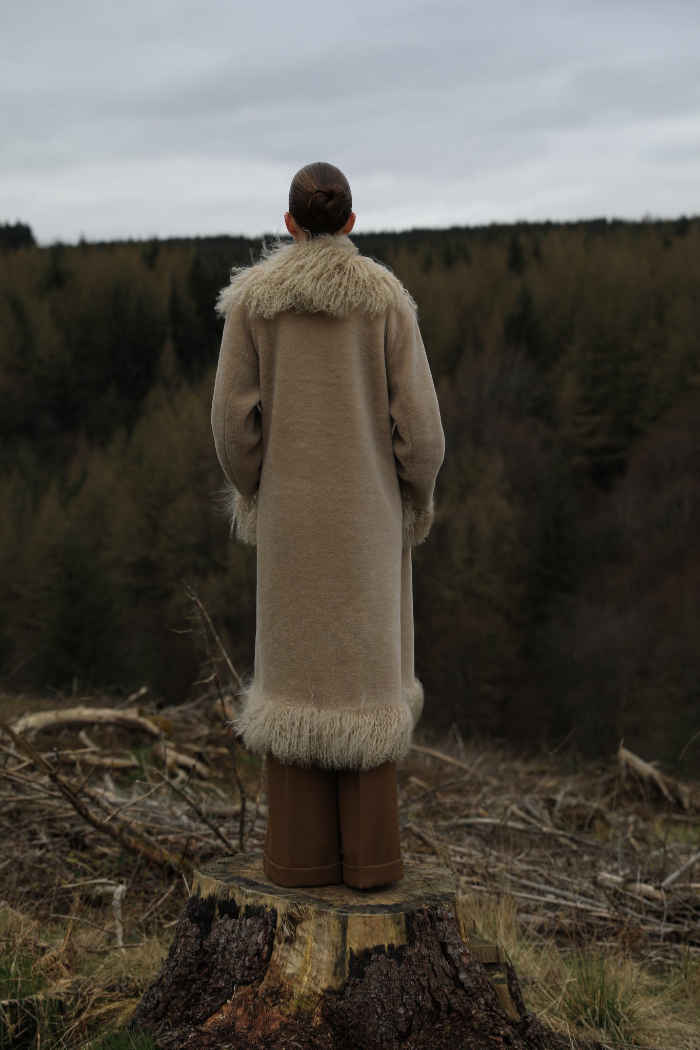 A bestselling long genuine shearling coat in beige/teddy color, designed by Josephine Jones. This luxurious coat features exquisite Mongolian fur trims, offering warmth and style for any occasion.