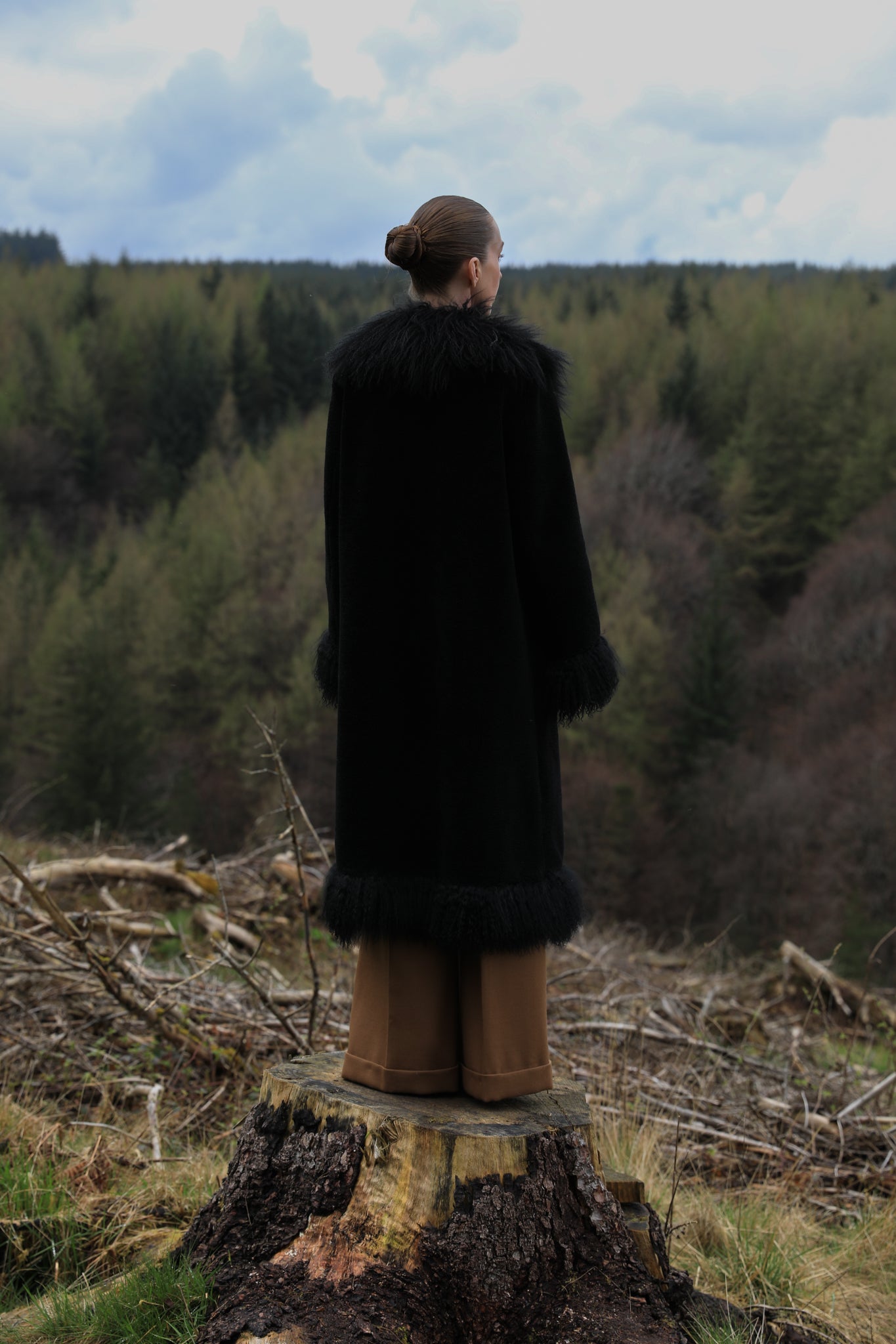 Black long genuine shearling coat with Mongolian fur trims from Josephine Jones - A bestselling luxury outerwear piece exuding elegance and warmth.