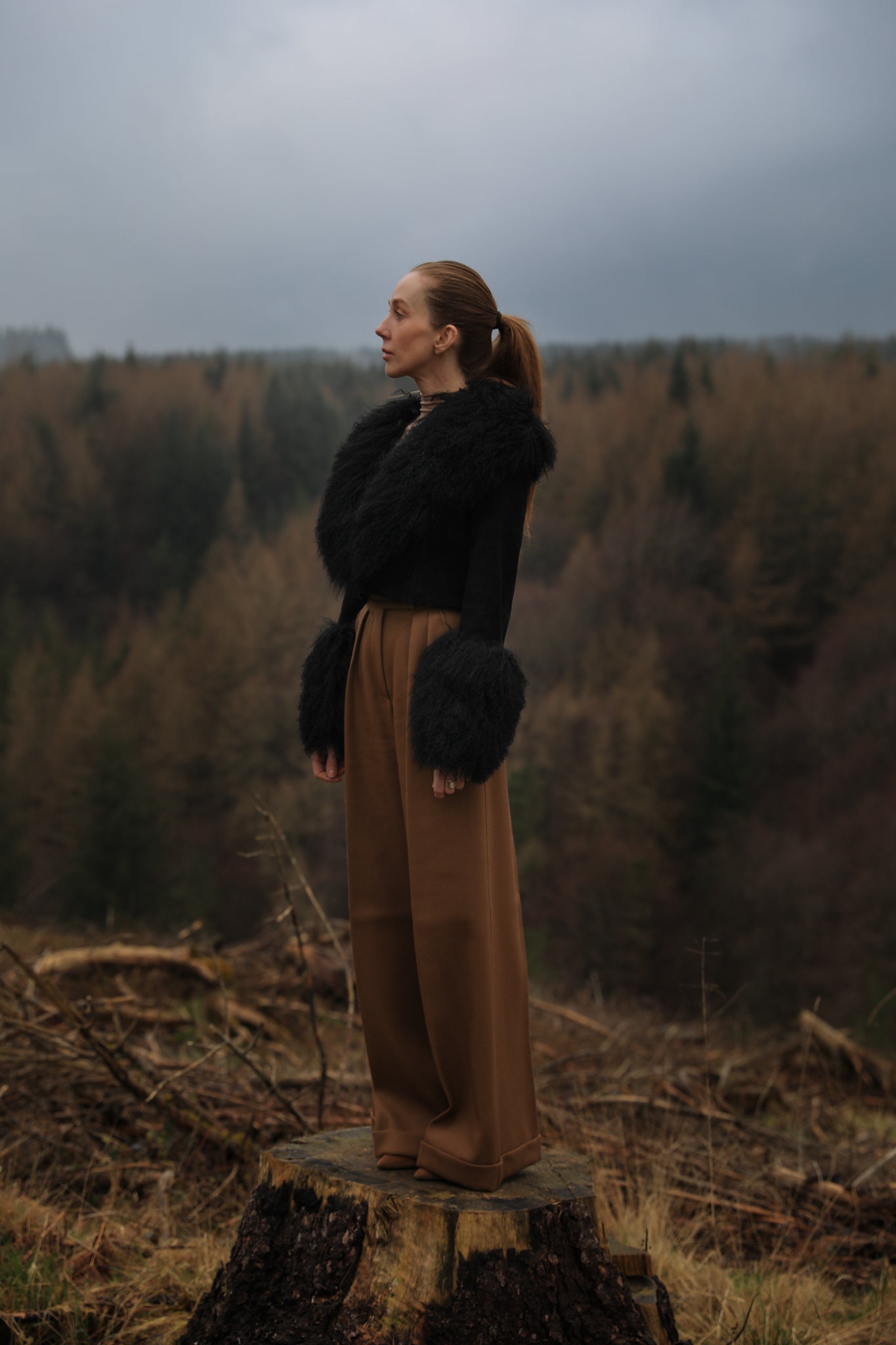 A sophisticated black genuine suede cropped jacket coat from Josephine Jones, featuring a luxurious Mongolian collar and cuffs. Perfect for adding a touch of elegance to any outfit.