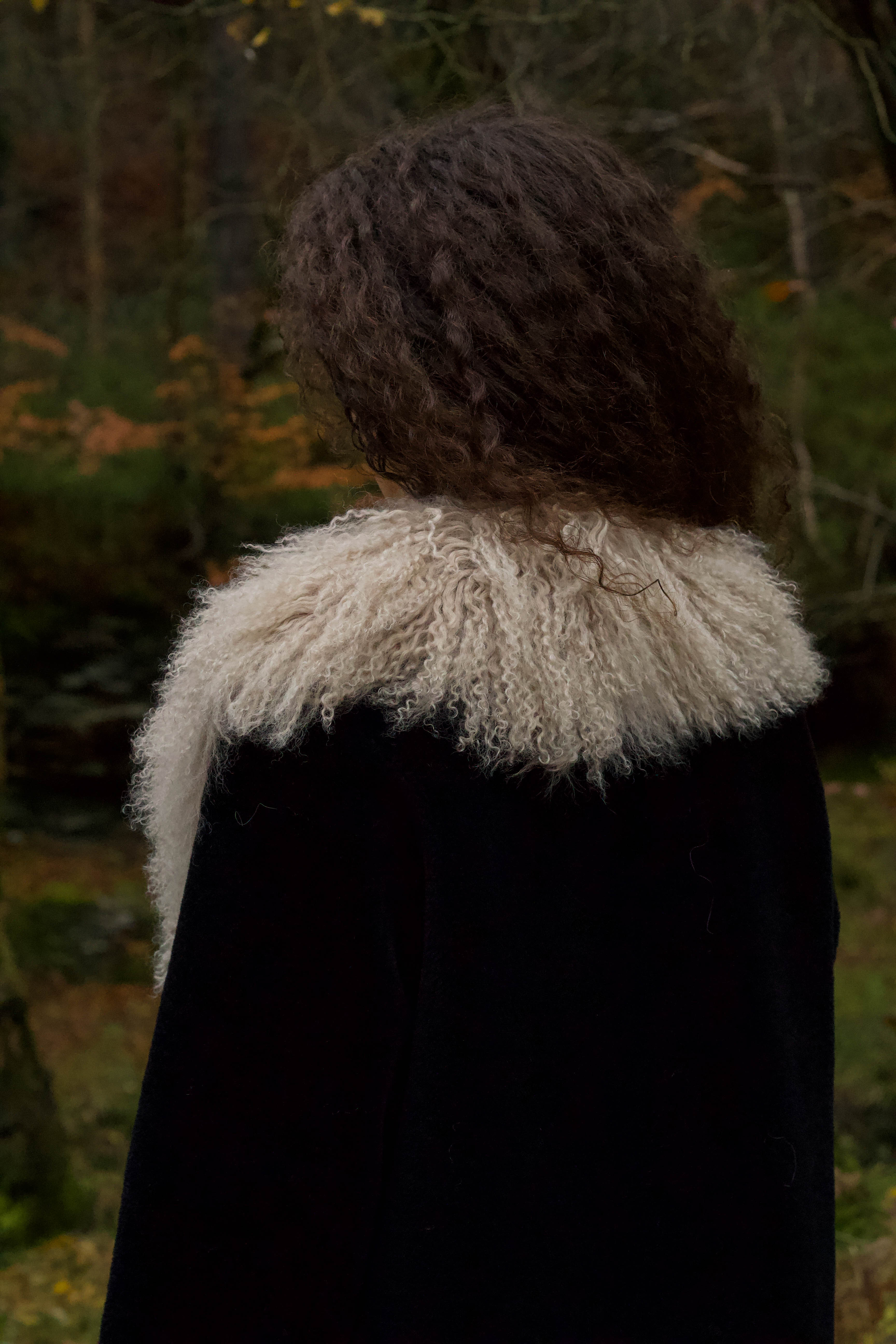 Josephine Jones bestselling long genuine shearling coat in beige and black, adorned with luxurious Mongolian fur trims. Stay chic and cozy in this elegant outerwear essential.